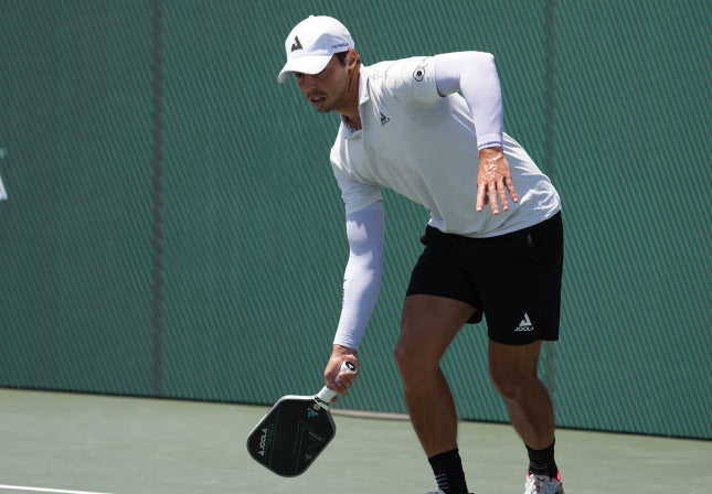 Close up image of Ben John's decked out in JOOLA apparel and about to return a ball with his JOOLA Pickleball paddle.